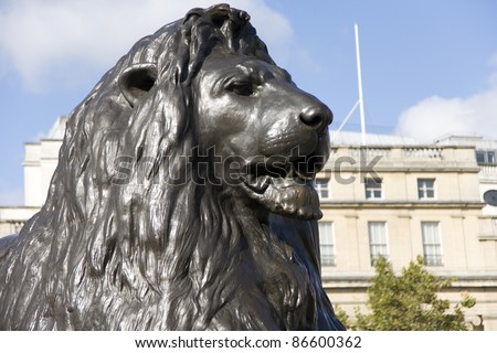 The four lion statues surrounding Nelson\'s column in Trafalgar Square are one of the most famous places for tourists.