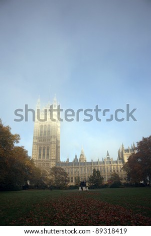 London Victoria Tower, in fog, stands at the House of Lords end of the Palace of Westminster.
