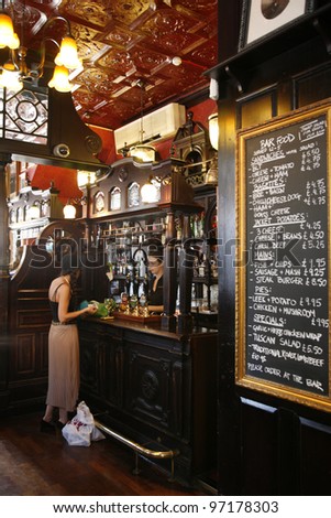 LONDON - JUNE 26: Interior of pub, for drinking and socializing, focal point of the community, on June 26, 2011, London, UK. Pub business, now about 53,500 pubs in UK, has been declining every year