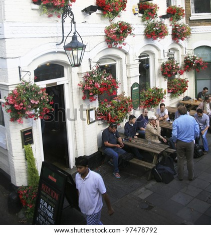 LONDON - JULY 16: Exterior of pub, for drinking and socializing, focal point of the community, on July 16, 2010, London, UK. Pub business, now about 53,500 pubs in UK, has been declining every year