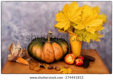 Autumn still life / Autumn still life in the studio with pumpkin, fruit and a bouquet of leaves.