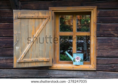 Window / Yellow window in a log house.