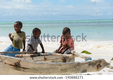 TANZANIA, ZANZIBAR: MARCH 26 2013: young happy african boys on fishing boat waiting for parents