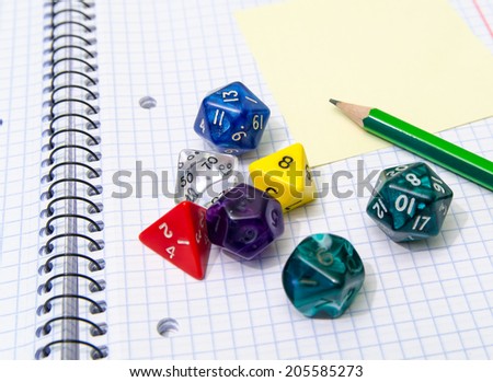 role playing dices lying on exercise book - stock photo