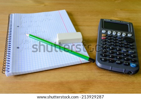 workplace, study place with calculator, workbook and pencil - stock photo