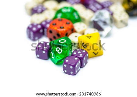 multiple colorful role playing dices lying on isolated background - stock photo