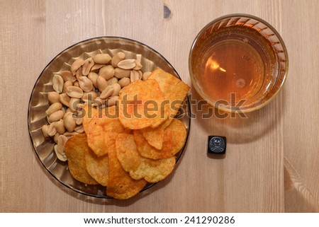 unhealthy snacks on table with skull dice - stock photo