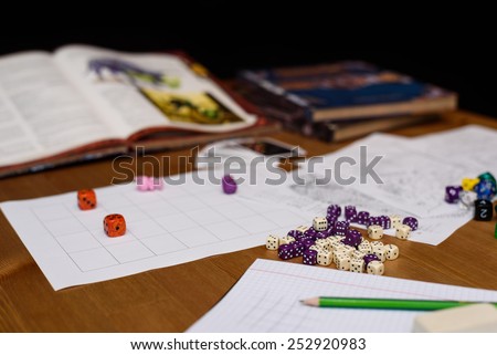 role playing game set up on table isolated on black background - stock photo