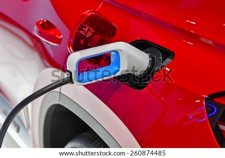 the electric vehicle charging cable inserted in plug