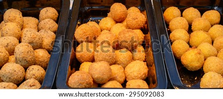 ruddy crispy cheese balls with spices in a metal tray