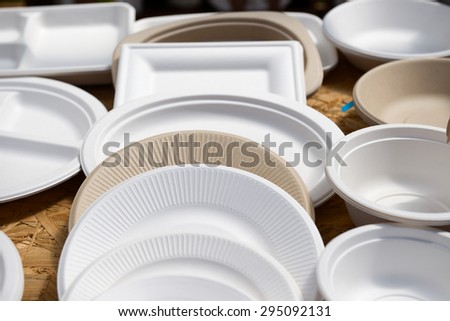 a variety of paper disposable plates of different colors