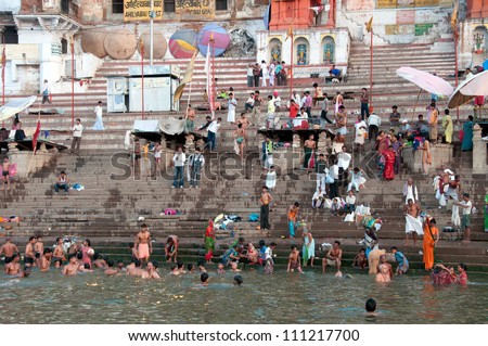VARANASI, INDIA - MAY 15: An unidentified group of Indian people wash themselves in  river Ganga on MAY 15, 2012  in Varanasi, Central India. The holy ritual of washing is held every day.