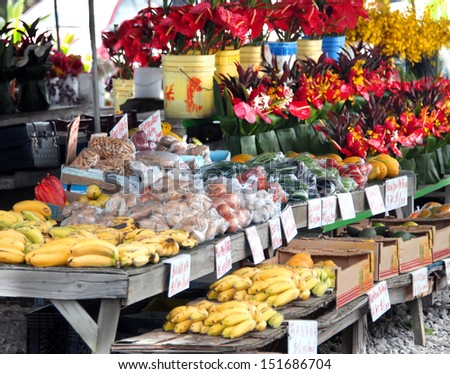 Hilo\'s Farmer\'s Market is filled with fruits and vegetables and buckets and bouquets of fresh cut tropical flowers.