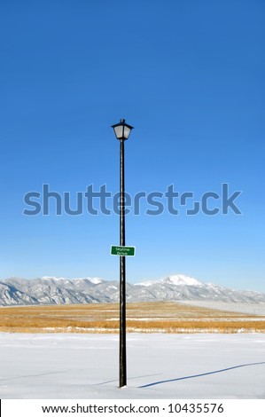 Lamp post has street sign that reads \