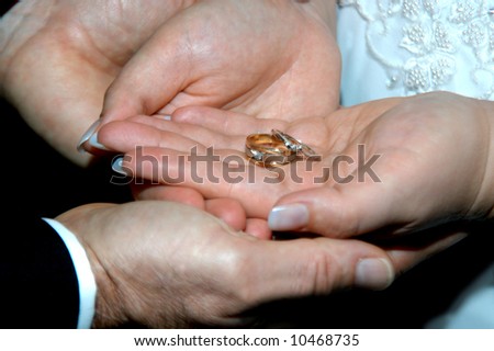  Husband cups his new wife 39s hands She is cupping their wedding rings