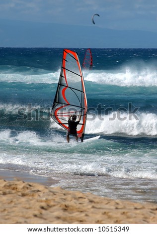 Windsurfer turns sailboard into the wind and heads out to sea.  Blue skies and water.