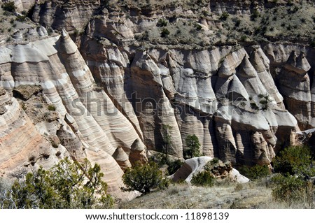 Tent Rocks in New Mexico is arid and dry.  Unusual rock formations resembling \