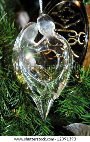 Beautiful Christmas ornament of Mary and Joseph and baby Jesus.  Crystal ornament with glowing light behind halo of child.