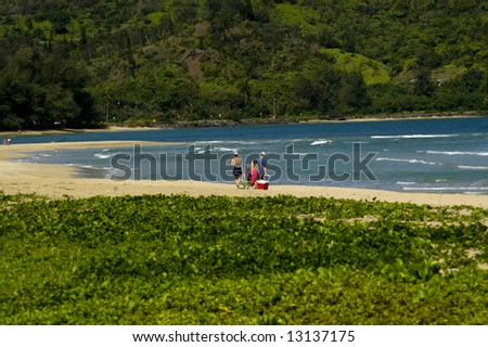 Beach day for family.  Deserted beach with sunshine and blue water.  Kauai, Hawaii.