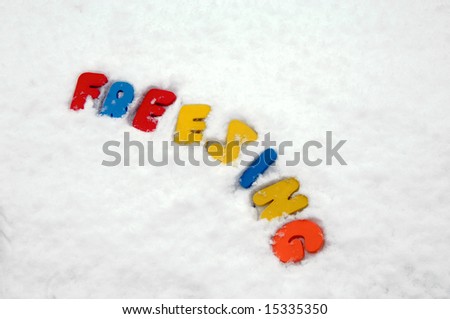 Colorful letters are pressed into the snow spelling \