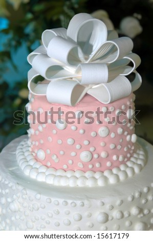 stock photo Beautiful pink and white wedding cake topper has loopy bow and 
