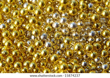 Garland of shiny gold lays in a bright cluster of gold.