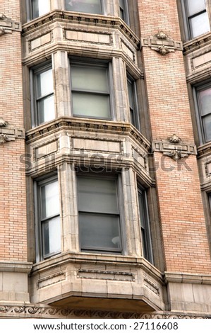 Apartment building in downtown philadelphia.  Bay windows with sculpture attached to each level.