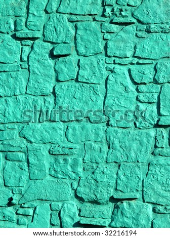 Background is filled with vivid turquoise painted stones in various sizes and shapes.
