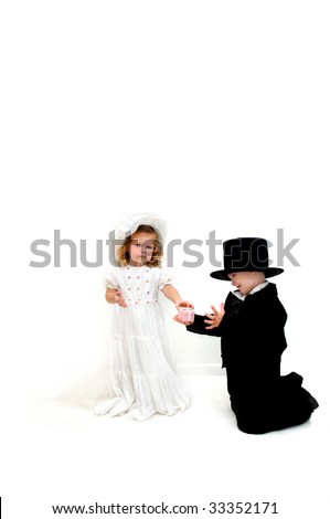 stock photo Small boy kneels with wedding ring