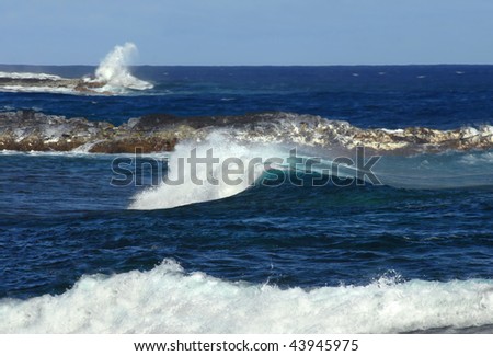 Three levels of white water are in photo of Kapoho Coast.  One -high crash of water against rocks, second-cresting curl of wave, third -foamy rushing water as it hits the shoreline.