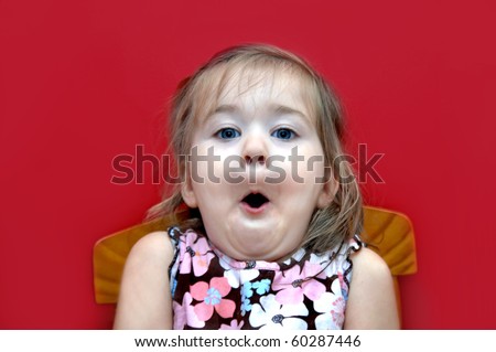 stock photo Little girl sucks in her breath in surprise She is sitting in