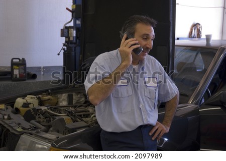 a mechanic is on the phone giving a customer some information