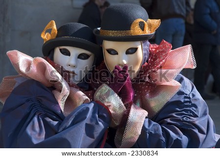 a couple with purple gloves enjoy Carnival in Saint Marks Square in Venice,Italy.