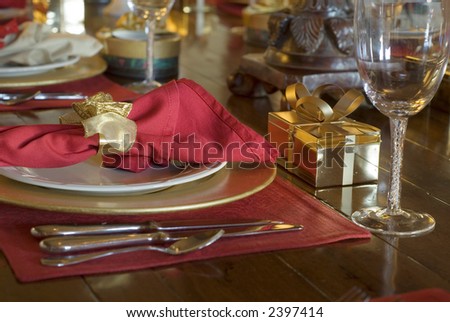 gift box at table setting with silverware and dinner plates and wine glasses