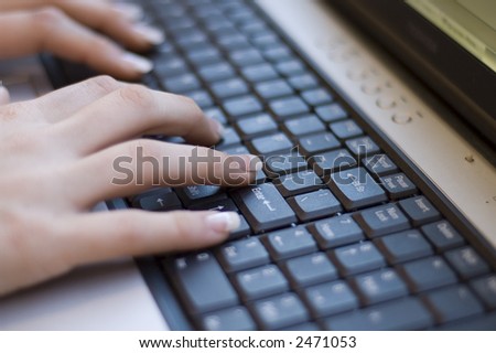 young womans manicured hands on keyboard