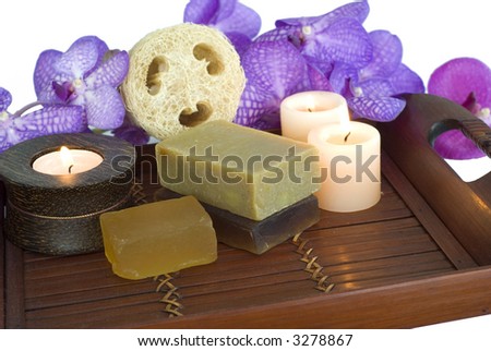handmade spa soap and loofah natural sponge with candles on bamboo tray