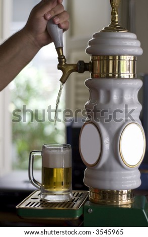 bartender filling a mug up with beer from a tap