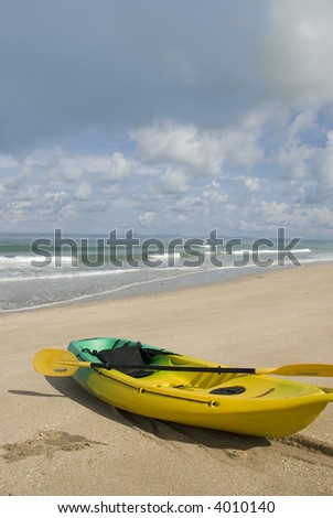 Ocean Kayak on the beach with cloudy sky
