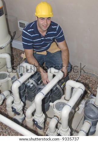 blue collar worker inspecting pool filter pumps