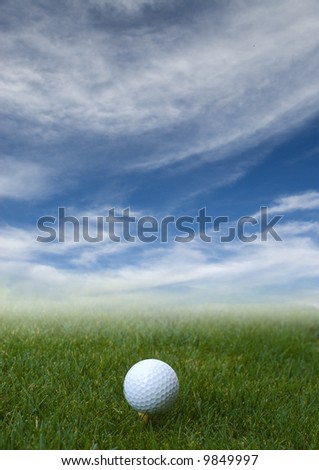 golf ball on the grass with blue sky