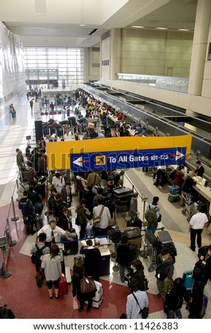 crowds of people waiting in line at an airport