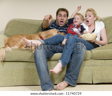 young family watching movie at home