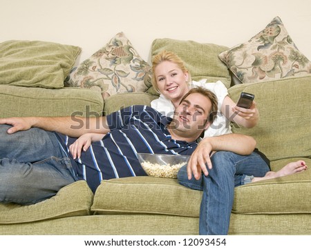 young couple watching movie at home