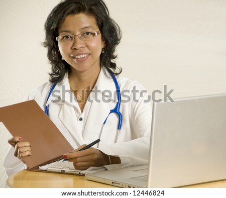 Smiling and confident female Asian Doctor sitting down.