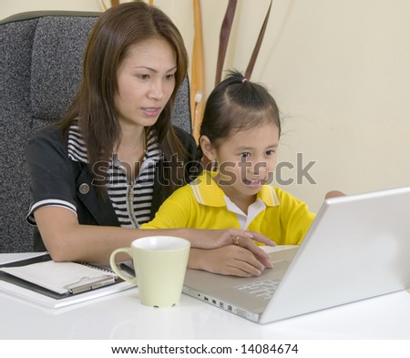 Asian Mom and daughter with computer