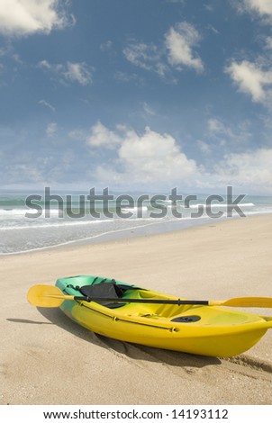 Ocean kayak on the beach with blue sky