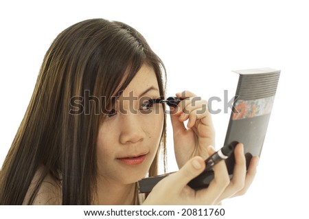 stock photo Attractive young Asian girl putting on makeup