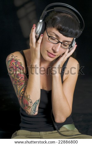 Music Tatoos on Emo Girl With Tattoo Listening To Music On Headphones Stock Photo