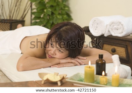 Woman laying down on massage table at spa