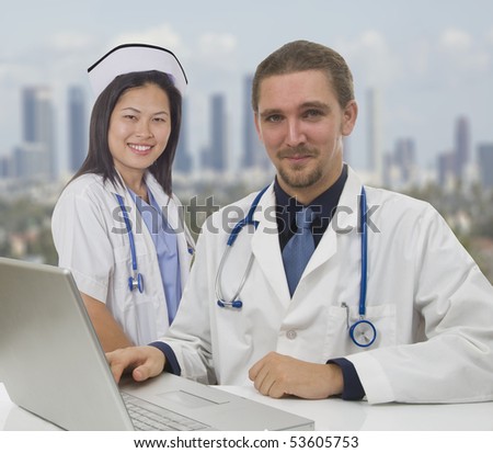 Doctor and Nurse sitting with computer at desk